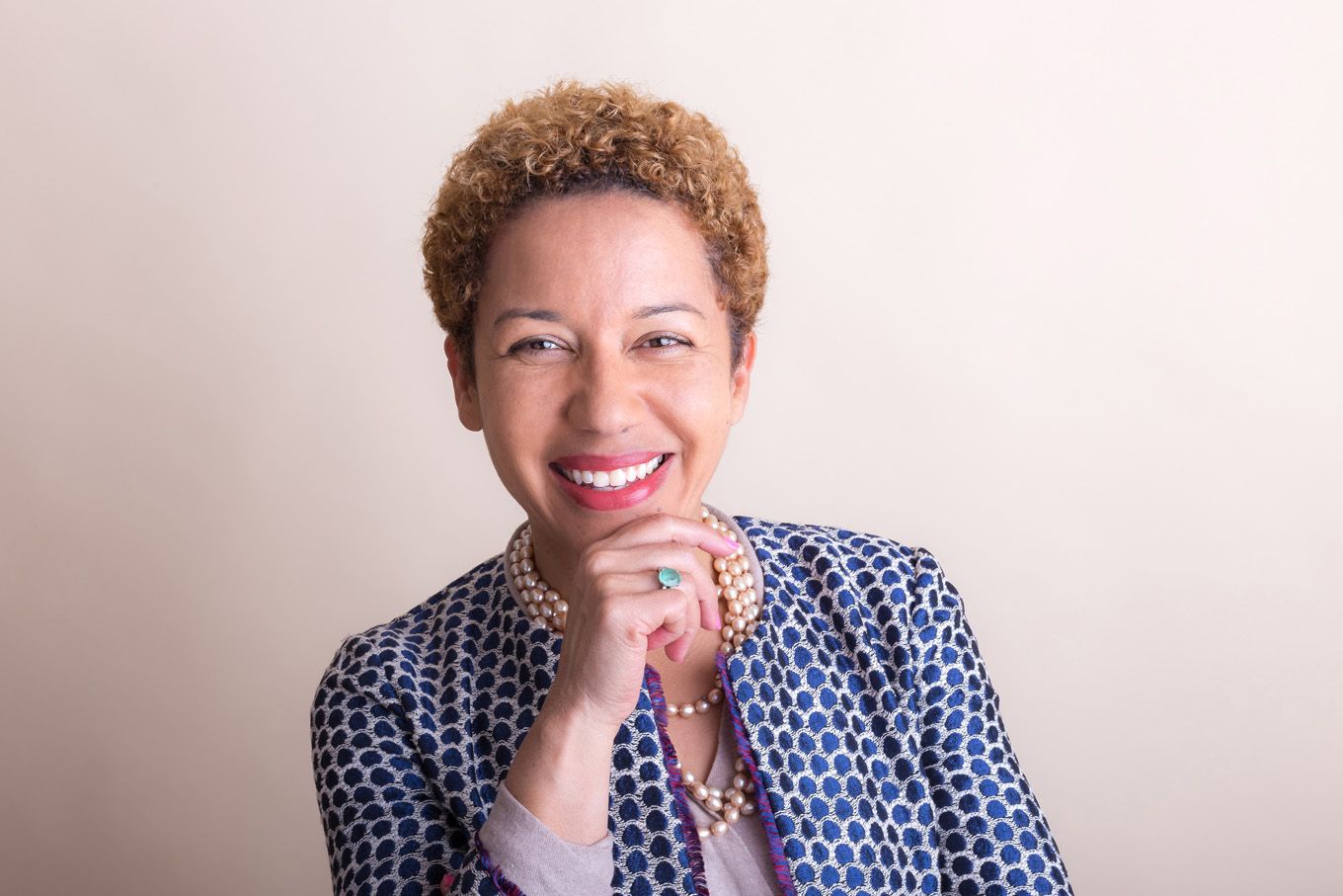 A portrait of a woman taken in a studio set up with backdrop and lighting equipment